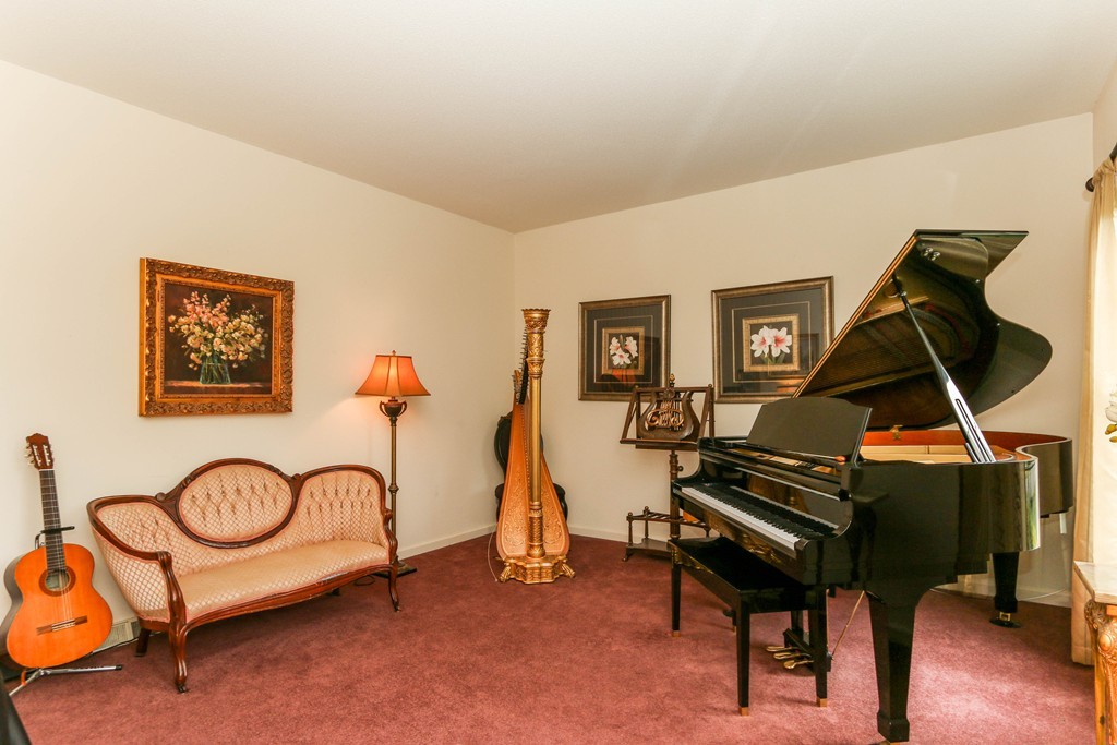 12 Bellows Road Wilbraham, MA 01095 - Photo 6 of 30 a living room with furniture a piano and a flat screen tv