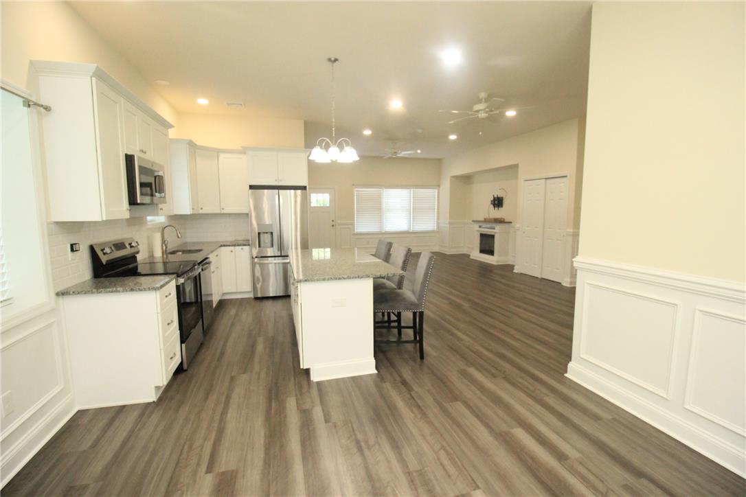 3083 Penn Allen Road, Unit B Nazareth, PA 18064 - Photo 2 of 21 A contemporary open-concept layout features rich wood flooring, a gleaming white kitchen, and an inviting breakfast bar.