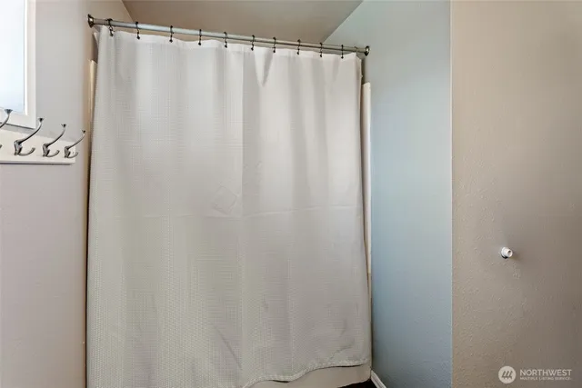 a bathroom with a shower curtain and a sink