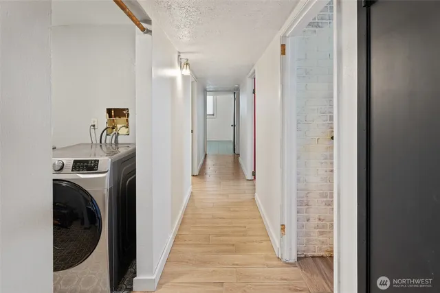 a view of a hallway with washer and dryer