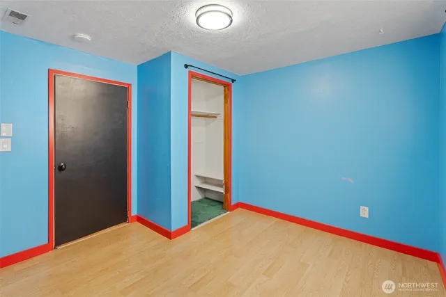 a view of a room with a wooden floor and bathroom