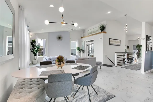 a dining room with furniture and a chandelier
