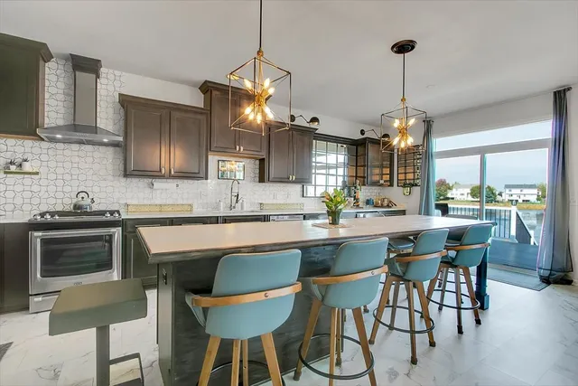 a kitchen with stainless steel appliances a dining table chairs and white cabinets