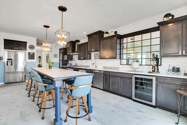 a kitchen with a table chairs sink and cabinets