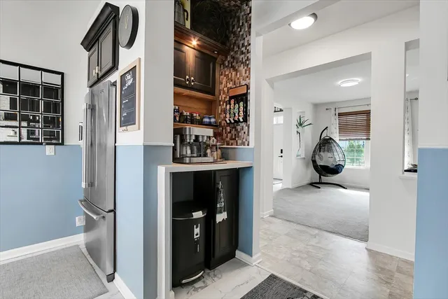 a bedroom with furniture and a large window