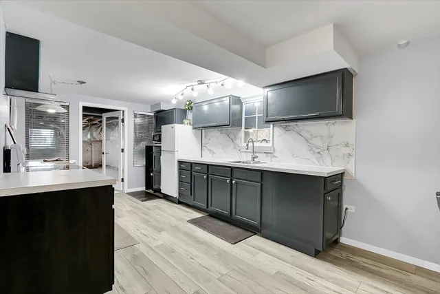 a kitchen with a stove and a refrigerator