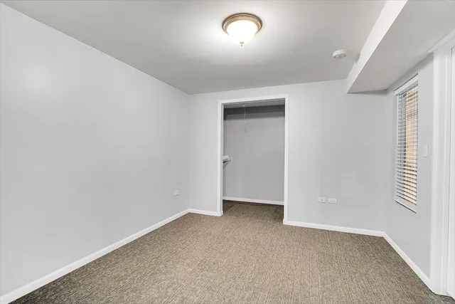 a view of empty room with wooden ceiling