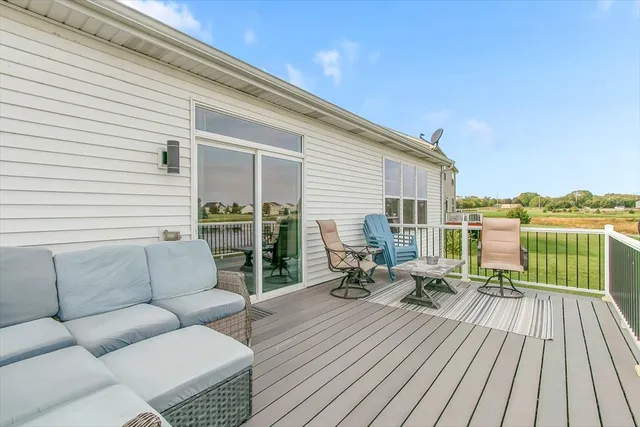 a balcony with furniture and wooden floor
