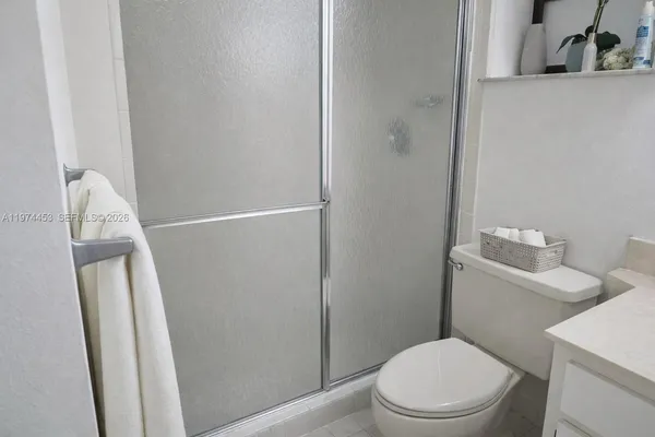 a white toilet sitting next to a bathroom sink