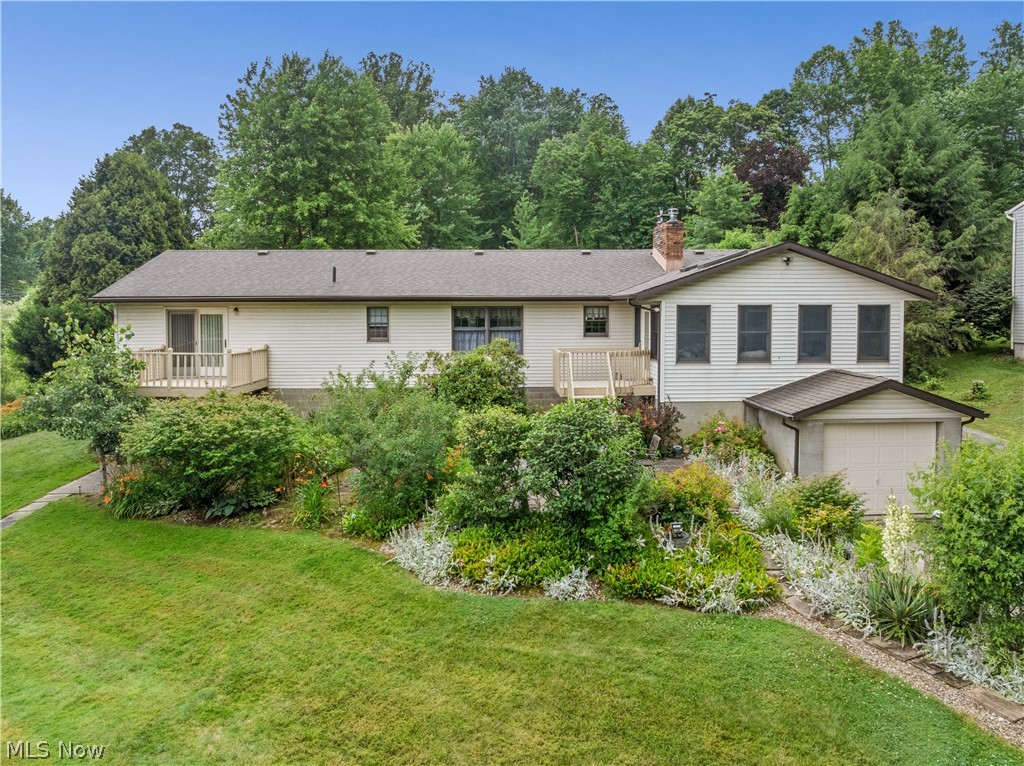 1835 Lynn Road Kent, OH 44240 - Photo 3 of 48 Front exterior featuring white siding, a shingle roof, and a wood-decked patio