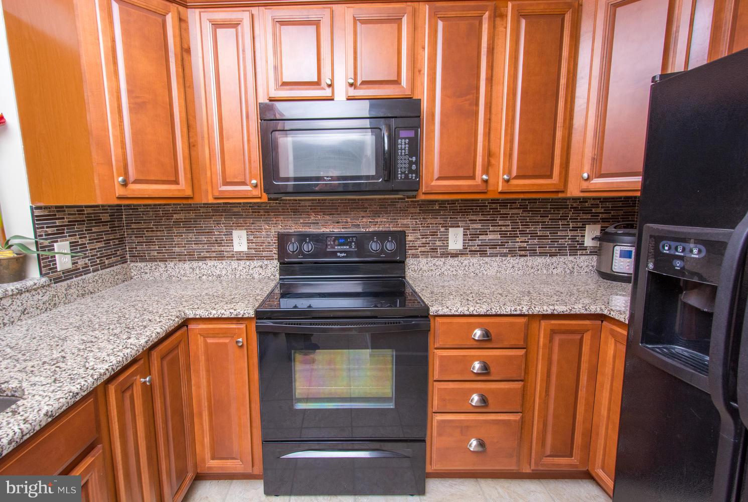 606 Moonglow Road, Unit 203 Odenton, MD 21113 - Photo 14 of 29 a kitchen with stainless steel appliances granite countertop cabinets and a counter top space