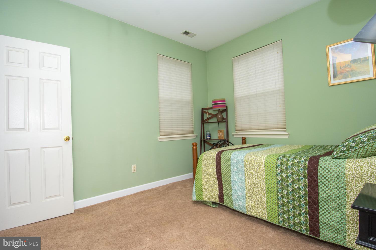 606 Moonglow Road, Unit 203 Odenton, MD 21113 - Photo 18 of 29 a bedroom with a bed and a window