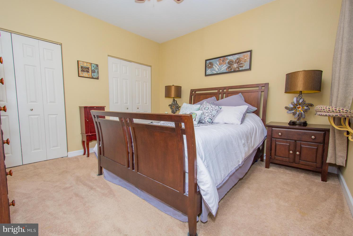 606 Moonglow Road, Unit 203 Odenton, MD 21113 - Photo 20 of 29 a bedroom with a bed and dresser