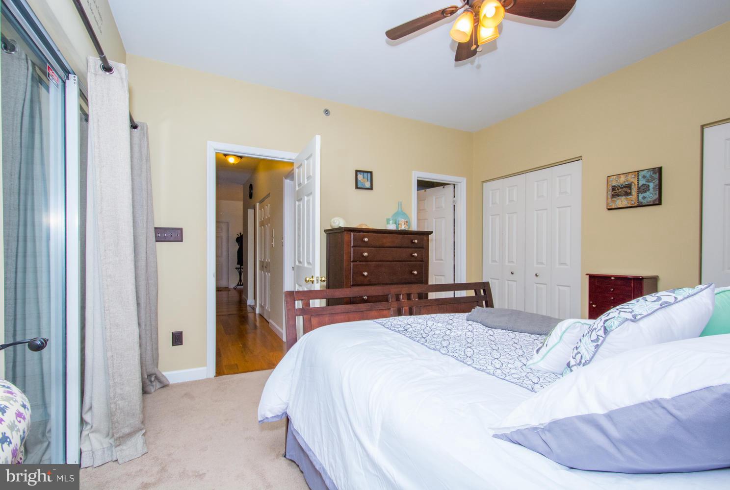 606 Moonglow Road, Unit 203 Odenton, MD 21113 - Photo 21 of 29 a bedroom with a bed and a chandelier