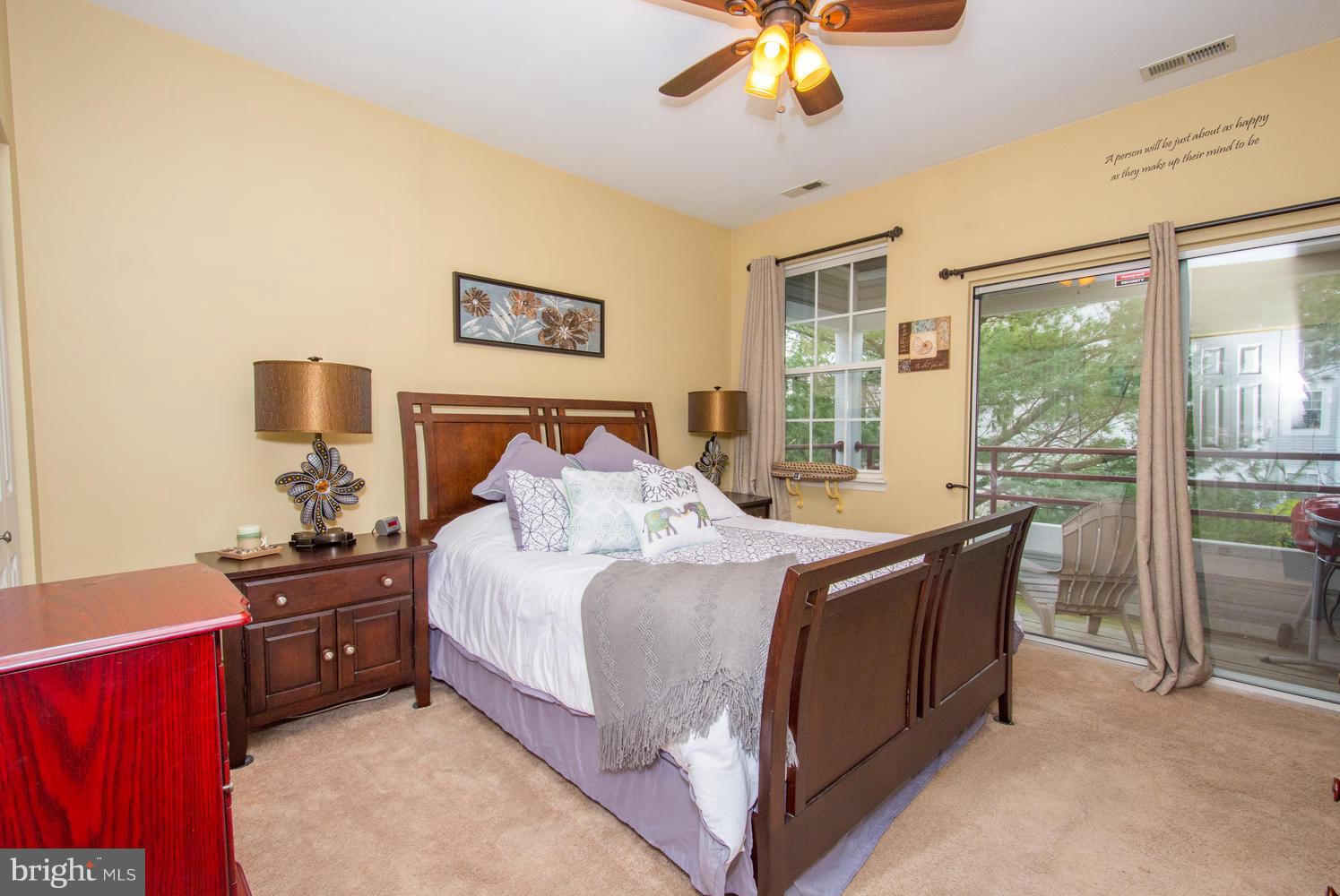 606 Moonglow Road, Unit 203 Odenton, MD 21113 - Photo 23 of 29 a bed room with a bed and a chandelier