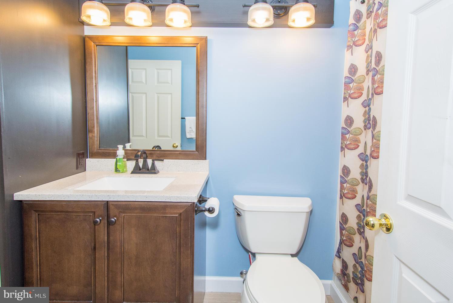606 Moonglow Road, Unit 203 Odenton, MD 21113 - Photo 25 of 29 a bathroom with a toilet a sink and a mirror