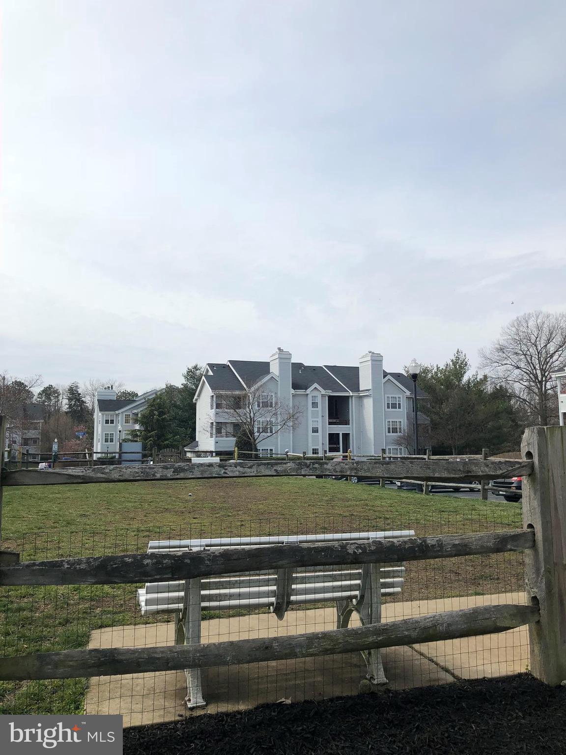 606 Moonglow Road, Unit 203 Odenton, MD 21113 - Photo 29 of 29 a view of a lake with houses in the background