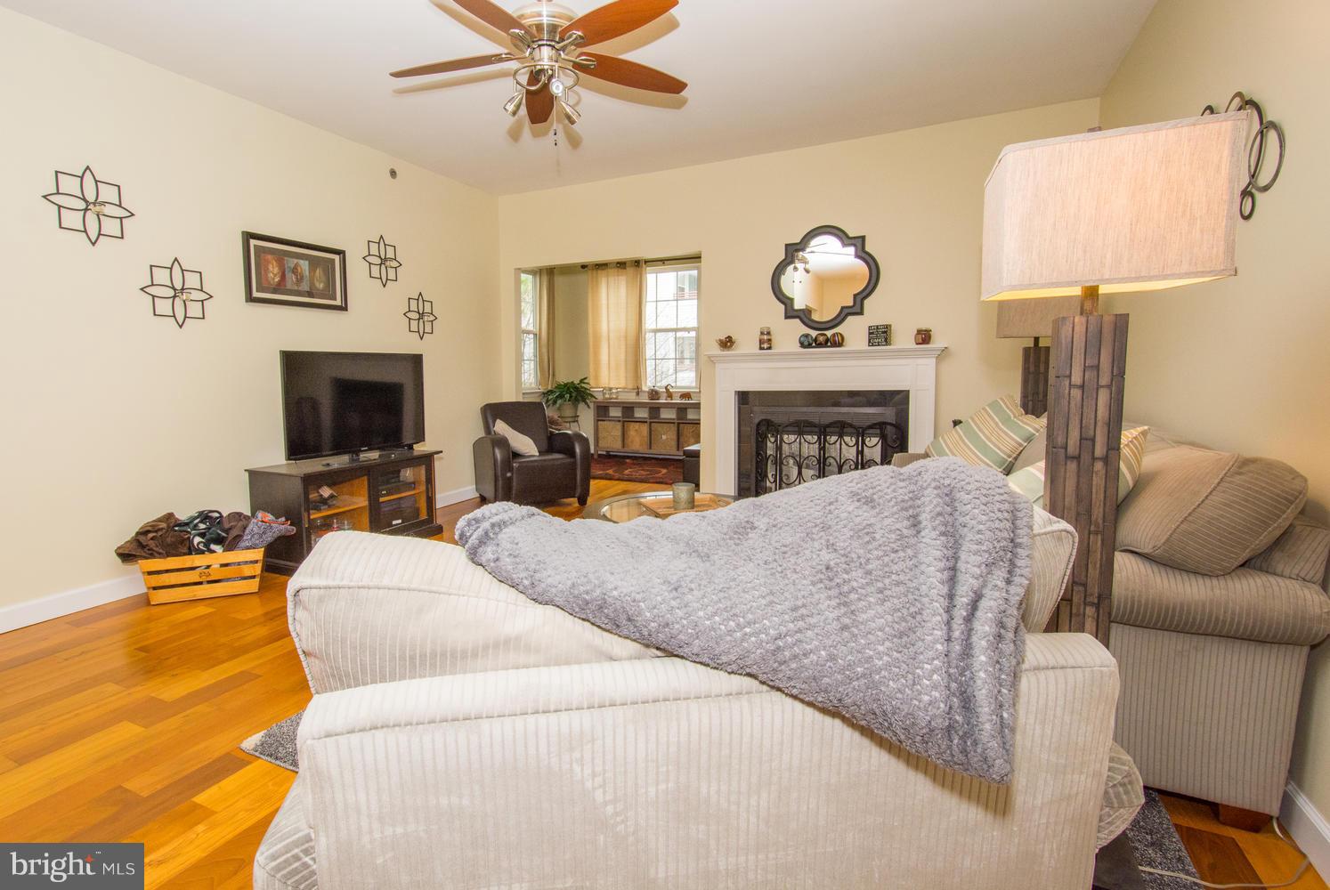 606 Moonglow Road, Unit 203 Odenton, MD 21113 - Photo 4 of 29 a living room with furniture a fireplace and a flat screen tv