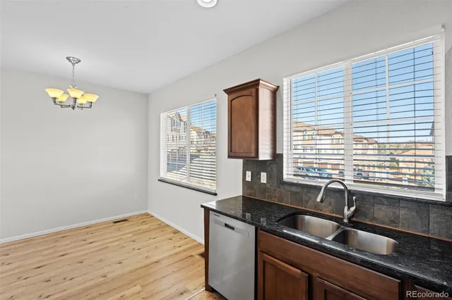 a bathroom with a granite countertop sink a large mirror and a shower
