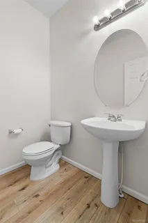 a bathroom with a sink toilet and a mirror