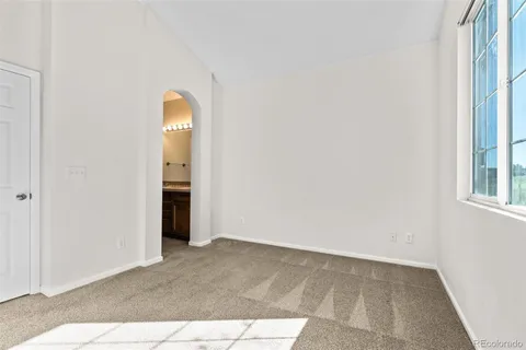 an empty room with windows and closet