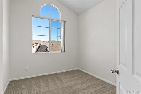 a view of a room that has a window and wooden floor