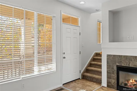 a view of a livingroom with wooden floor and a fireplace
