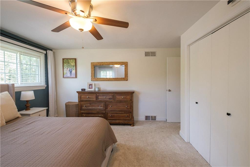 137 Easley Road Pittsburgh, PA 15237 - Photo 11 of 25 a bedroom with a bed and a chandelier