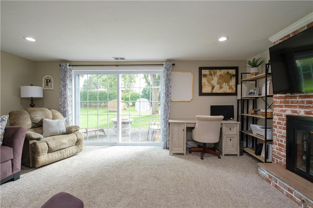 137 Easley Road Pittsburgh, PA 15237 - Photo 17 of 25 a living room with furniture a flat screen tv and a fireplace