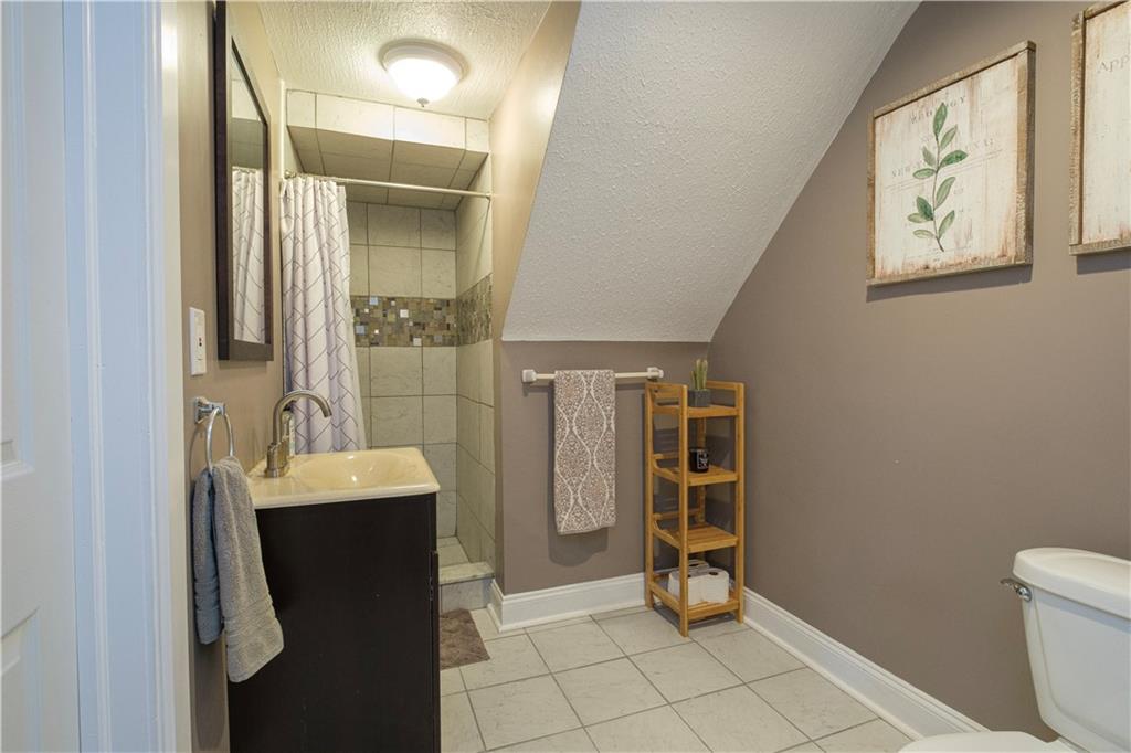 137 Easley Road Pittsburgh, PA 15237 - Photo 20 of 25 a bathroom with a sink a toilet and a mirror