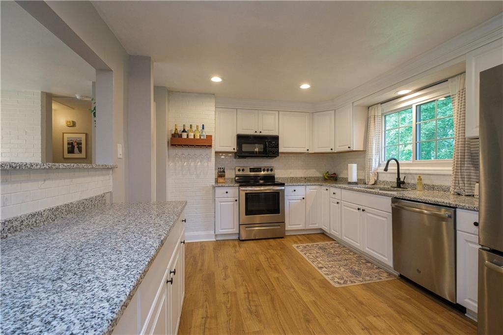 137 Easley Road Pittsburgh, PA 15237 - Photo 4 of 25 a kitchen with granite countertop a stove a sink and a refrigerator