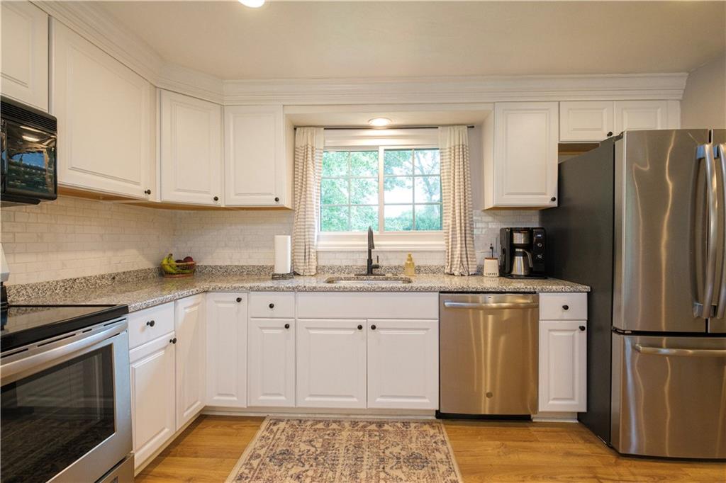 137 Easley Road Pittsburgh, PA 15237 - Photo 5 of 25 a kitchen with a refrigerator sink and cabinets