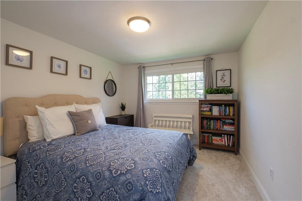 137 Easley Road Pittsburgh, PA 15237 - Photo 9 of 25 a bedroom with a bed a bookshelf and a book shelf