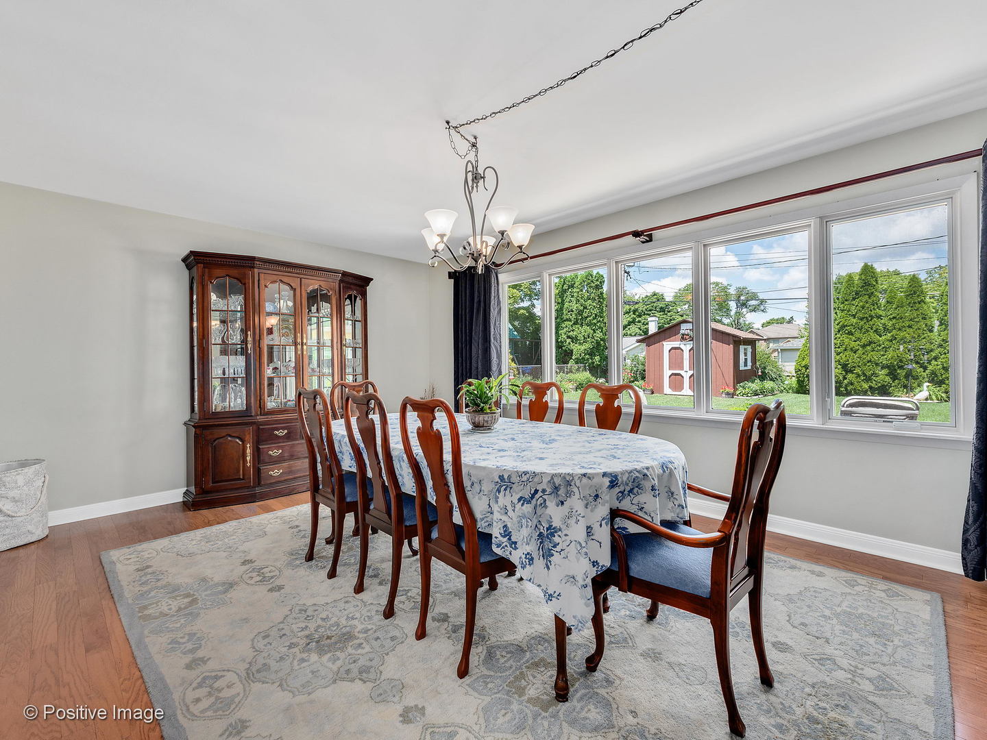 521 Ranch Road Wheaton, IL 60187 - Photo 6 of 22 a dining room with furniture a rug and a large window