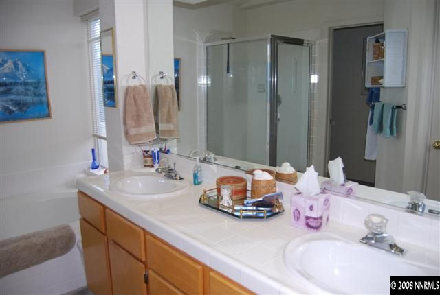 6212 Alpine Meadows Road Reno, NV 89519 - Photo 8 of 9 a bathroom with a double vanity sink mirror and shower