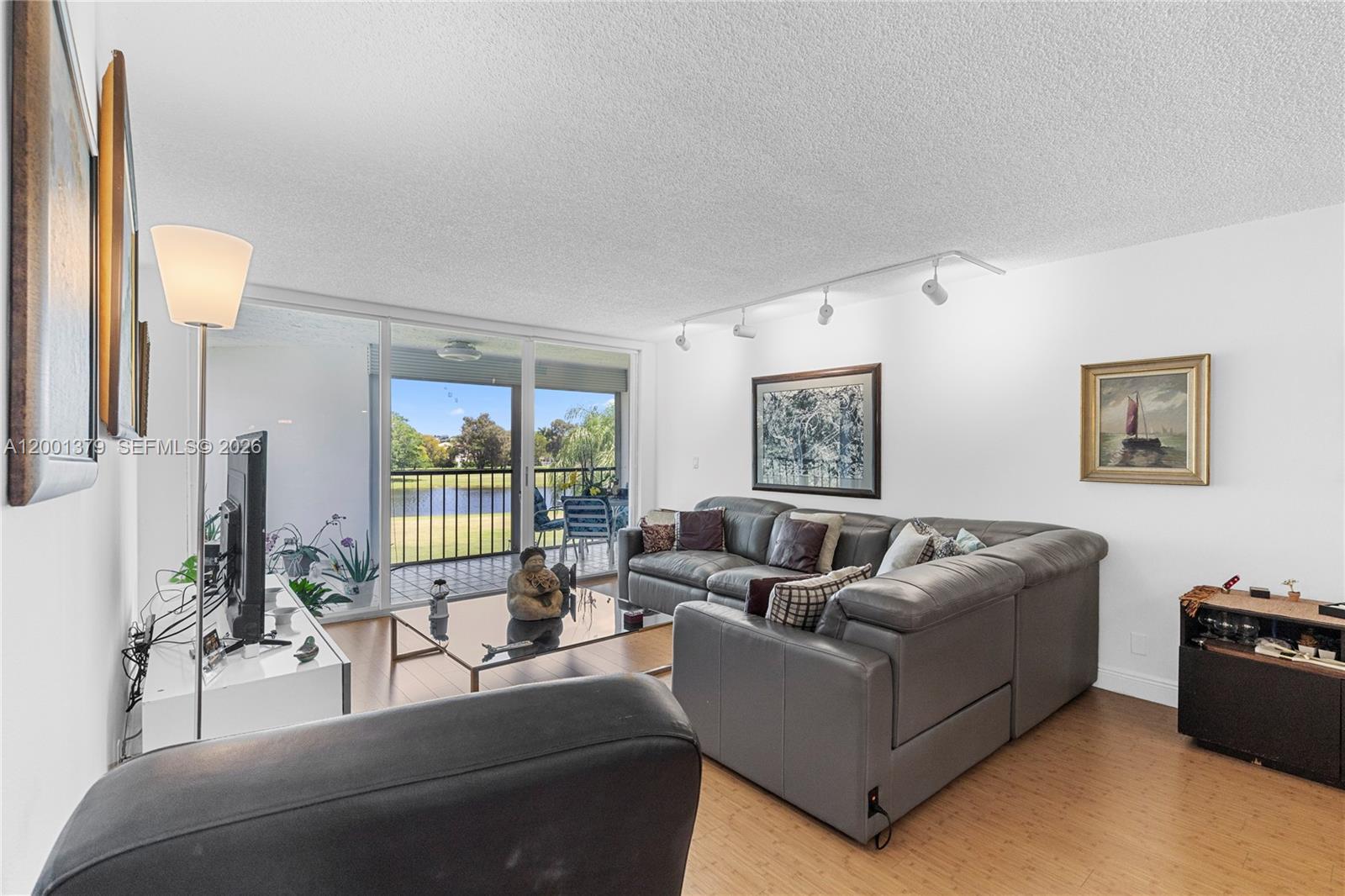 16251 Golf Club Road, Unit 311 Weston, FL 33326 - Photo 26 of 38 a living room with furniture and a large window