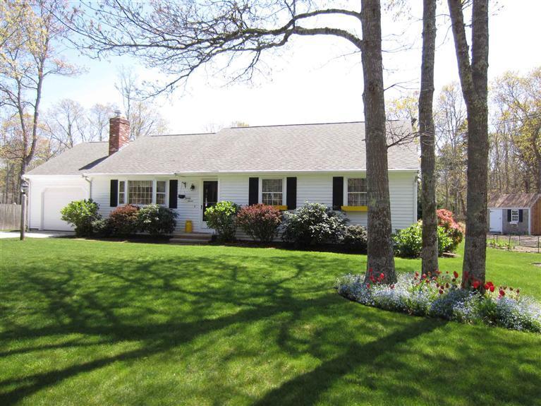27 Golf Course Road East Dennis, MA 02660 - Photo 1 of 16 a front view of a house with a garden and yard