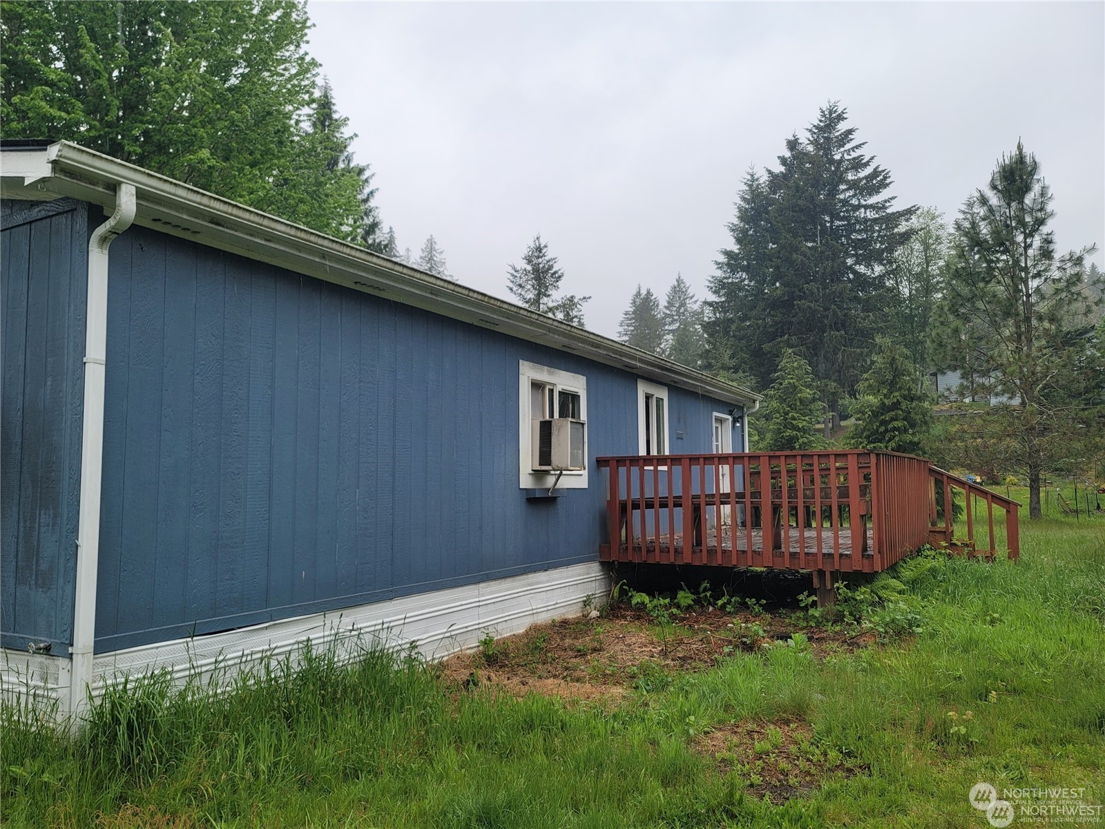 120 Wennassee Loop Silver Creek, WA 98585 - Photo 20 of 23 a view of a backyard with wooden fence and large trees