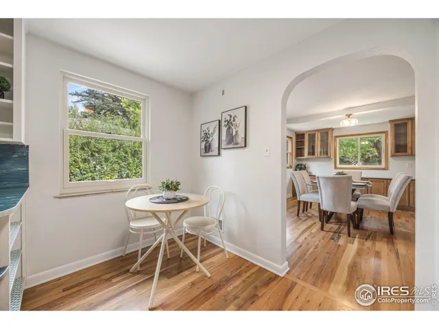 a dining room with furniture and wooden floor
