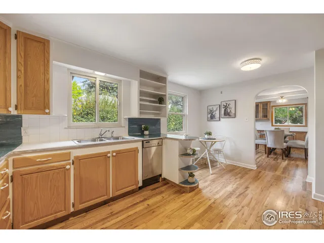 a open kitchen with a sink cabinets and wooden floor