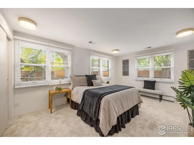 a bed room with a bed and a chair