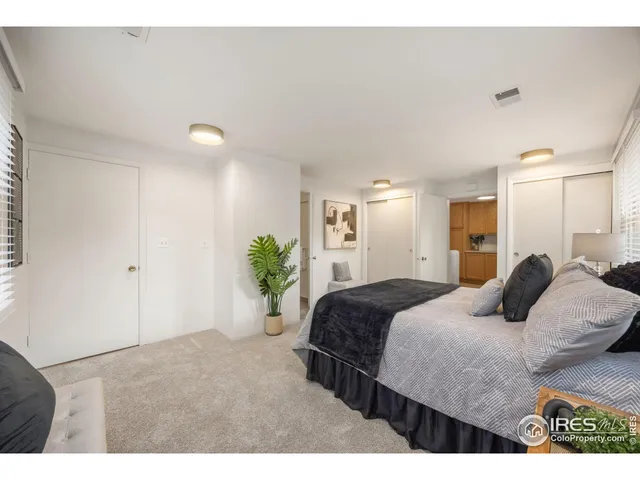 a bedroom with a bed and a potted plant