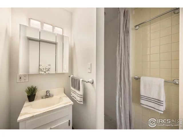 a bathroom with a sink a mirror and a shower