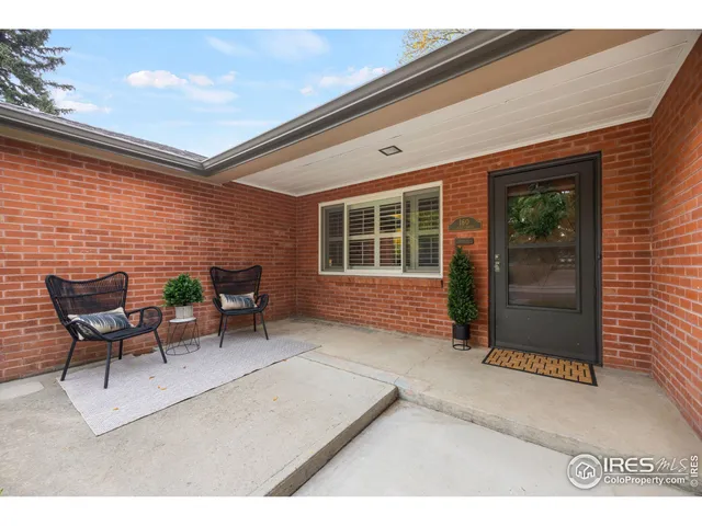 a backyard of a house with yard and glass windows