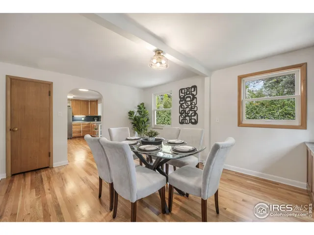 a dining room with furniture and wooden floor