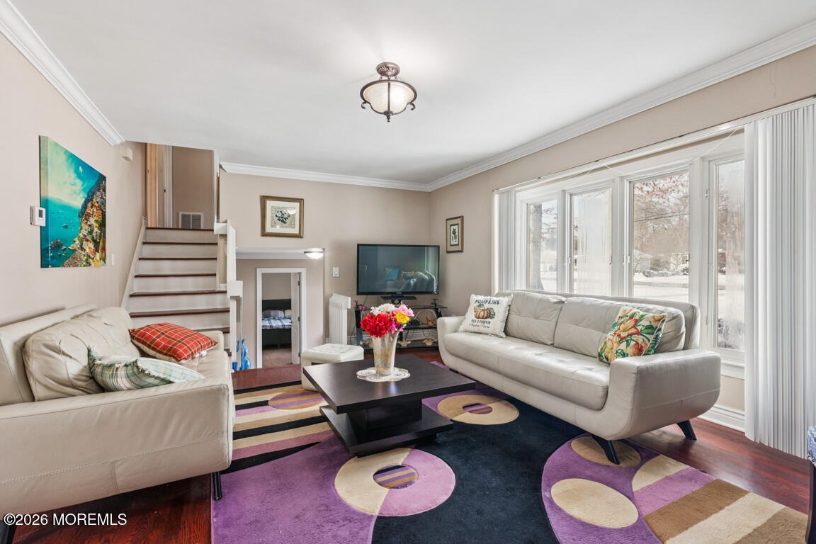 183 Pine Brook Road Manalapan, NJ 07726 - Photo 18 of 25 a living room with furniture and a flat screen tv