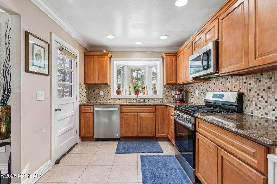 183 Pine Brook Road Manalapan, NJ 07726 - Photo 21 of 25 a kitchen with stainless steel appliances granite countertop a stove top oven a sink dishwasher and a microwave oven on the blue kitchen countertops