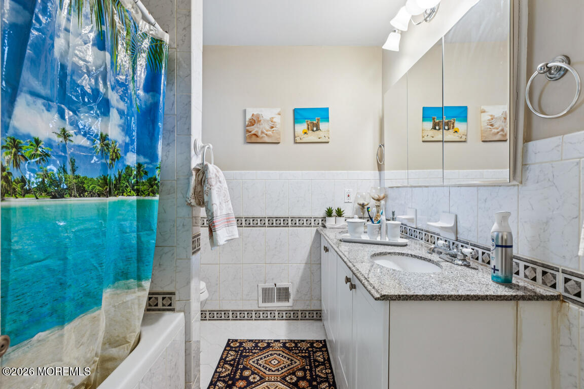 183 Pine Brook Road Manalapan, NJ 07726 - Photo 24 of 25 a bathroom with a sink and a mirror