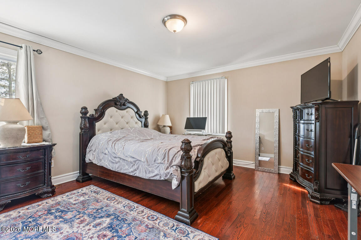183 Pine Brook Road Manalapan, NJ 07726 - Photo 4 of 25 a bedroom with a bed and wooden floor