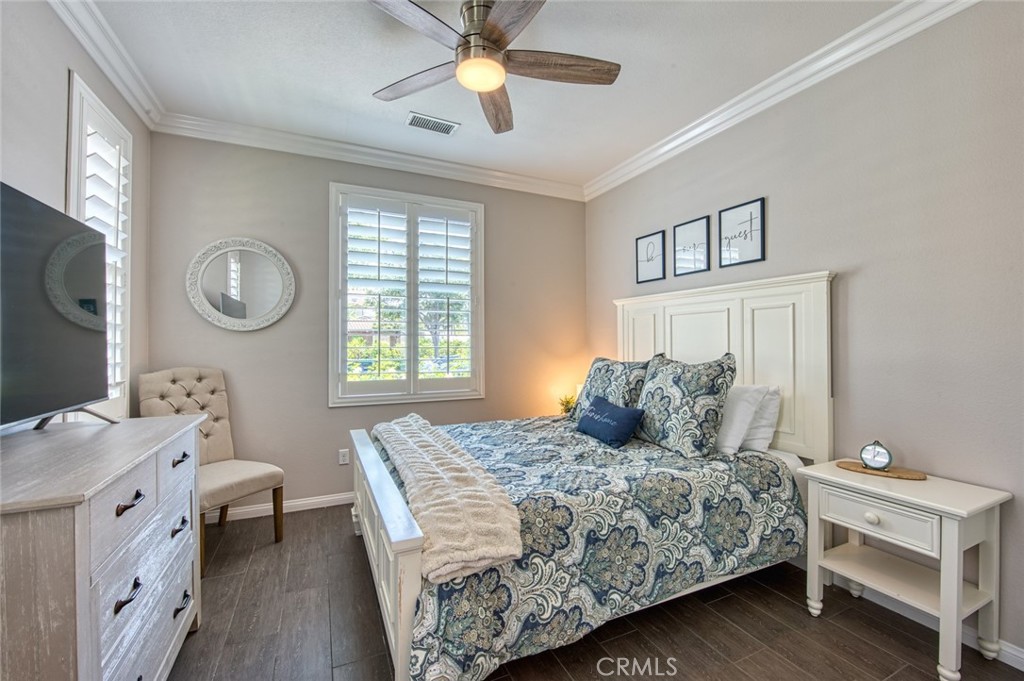 33 Lucido Street Rancho Mission Viejo, CA 92694 - Photo 16 of 37 a bedroom with a bed and a chandelier